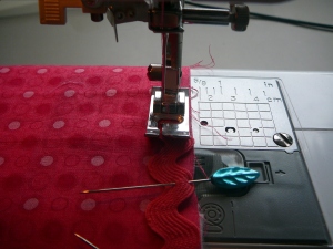 Sewing the rick rack to the front flap embellishment!